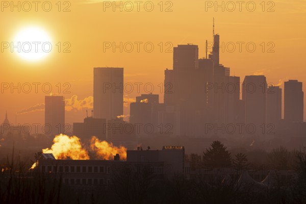 The sun rises behind Frankfurt's banking skyline, Frankfurt am Main, Hesse, Germany
