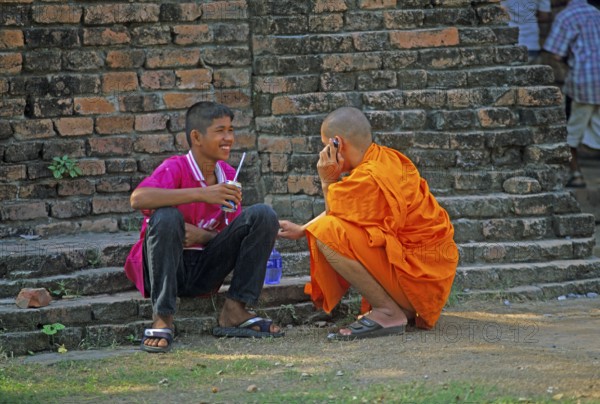 Monk talking on cell phone, teenager, Wat Phra Si Sanphet, Ayutthaya, Thailand, December 2002, vintage, retro, old, historic