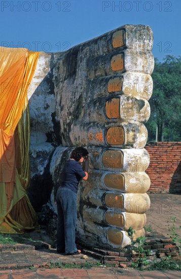Woman praying, statue of reclining Buddha, feet, Ayutthaya, Thailand, December 2002, vintage, retro, old, historic