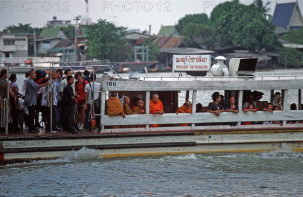 Liner on the Mae Nam Chao Phraya River, people, monks, children, Bangkok, Thailand, December 2002, vintage, retro, old, historic