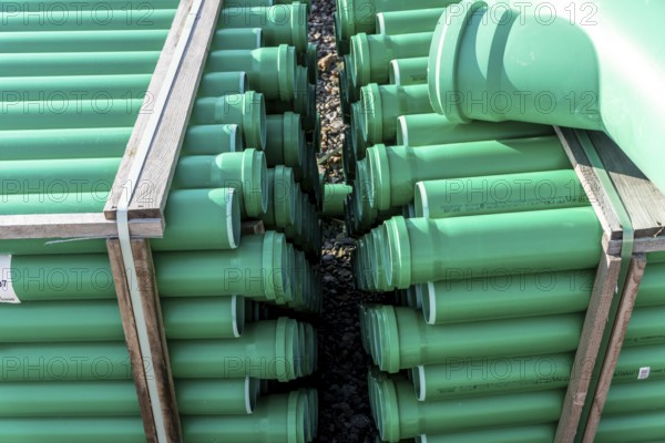 Symbolic picture construction site, sewage pipes for dirty and rainwater, for installation in the ground, plastic pipes, made of polypropylene, storage on a construction site