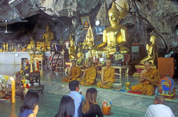 Buddha statue, monks and believers praying, Wat Tam Sua monastery near Krabi, Thailand, December 2002, vintage, retro, old, historic