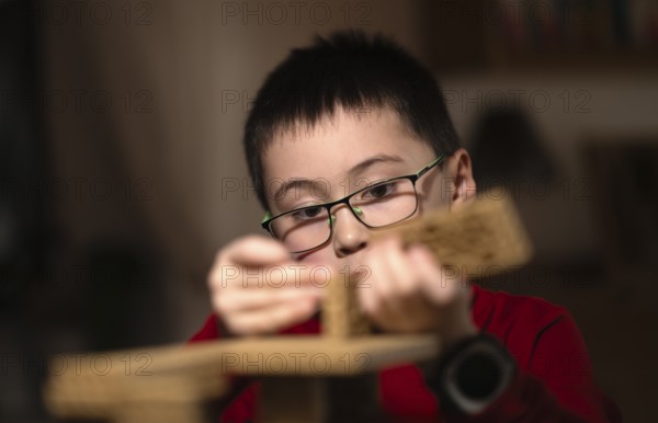 Boy, 6 years, glasses, multi-ethnic, plays concentrated, constructs, builds, Stuttgart, Baden-Württemberg, Germany