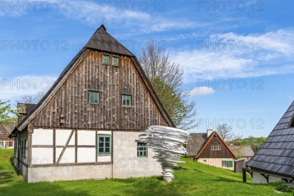 Sculpture, art installation Twister by artist and sculptor Alice Aycock, Purple Path art and sculpture trail of the European Cultural Region around the cultural capital Chemnitz, next to historic wooden houses in the Seiffen open-air museum, Ore Mountains, Saxony, Germany