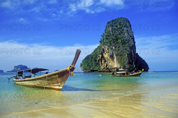 Rocks in the sea and longtail boats on Pranang Cave beach, two years in front of the tsunami, Krabi, Thailand, December 2002, vintage, retro, old, historic