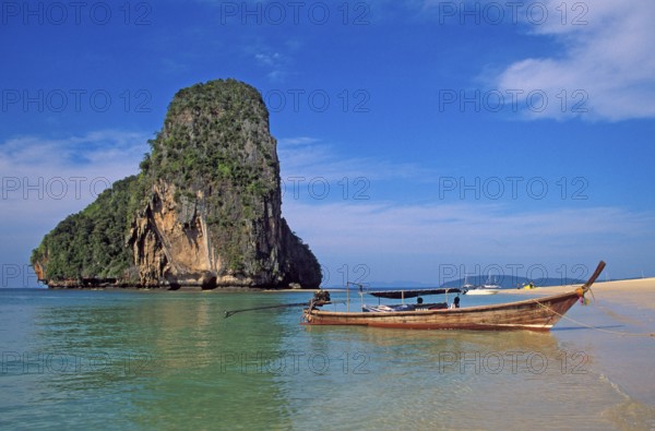 Rocks in the sea and longtail boat on Pranang Cave beach, two years in front of the tsunami, Krabi, Thailand, December 2002, vintage, retro, old, historic