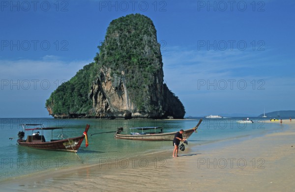 Rocks in the sea, people and longtail boats on Pranang Cave beach, two years in front of the tsunami, Krabi, Thailand, December 2002, vintage, retro, old, historic