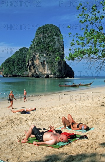 Rocks in the sea, people and longtail boats on Pranang Cave beach, two years in front of the tsunami, Krabi, Thailand, December 2002, vintage, retro, old, historic