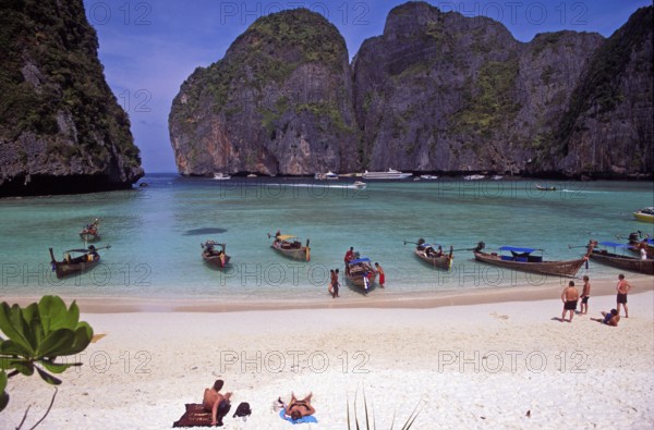 People, longtail boats on Maya Bay beach, known from the movie The Beach, one year in front of the tsunami, Ko Phi Phi Le, Thailand, December 2002, vintage, retro, old, historic