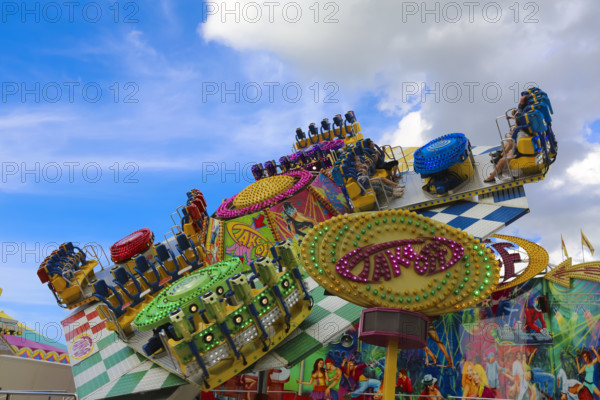 Fairground in Ulm Friedrichsau, folk festival, hustle and bustle, amusement park, amusement attraction, ride, blue sky, clouds, Ulm, Baden-Württemberg, Germany