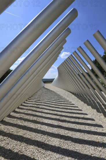 Art in public space, sculpture made of aluminum profile pipes by artist Martin Burchard, life's horizon path near Mundingen, light and shadow, gravel, clouds, blue sky, walk-in art, paths of reflection and refreshment on the Ehinger Alb, Baden-Württemberg, Germany