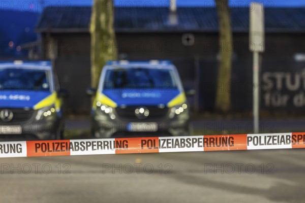 Flutter tape with the inscription police barrier. Behind them, police vehicles. Stuttgart, Baden-Württemberg, Germany