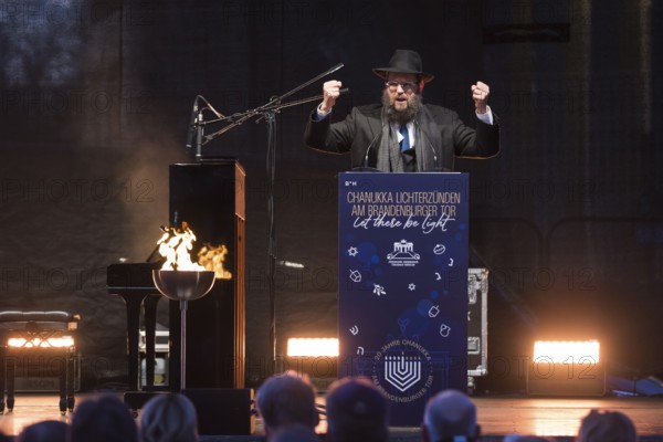 Yehuda Teichtal (Rabbi of the Chabad-Lubavitch movement) speaks at the lighting of lights to mark 20 years of Hanukkah in front of the Brandenburg Tor tor, Berlin, 17 December 2025