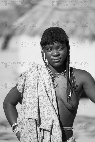 Black and white, portrait, brightly decorated woman of the Hakaona tribe, also Havakona or Hakawona, near Opuwo, Kunene, Namibia