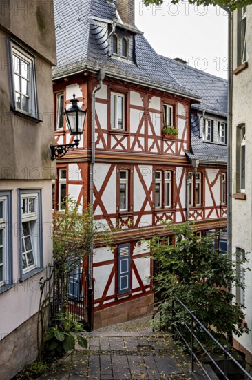 Idyllic half-timbered houses in a narrow alley with a nostalgic atmosphere, The historic old town of Marburg an der Lahn in Hesse