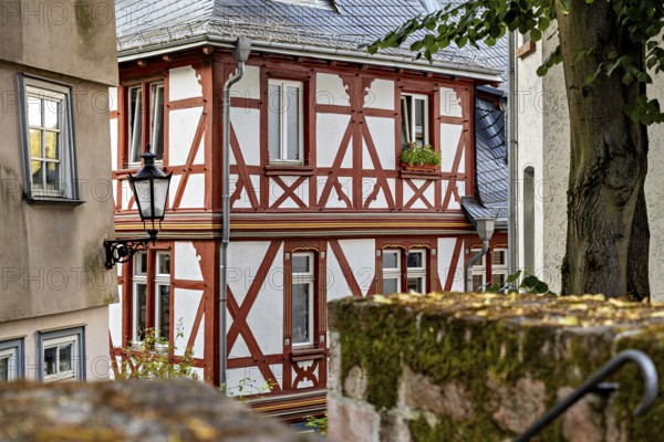 Rustic half-timbered building with wooden elements and lantern, surrounded by gardens, The historic old town of Marburg an der Lahn in Hesse