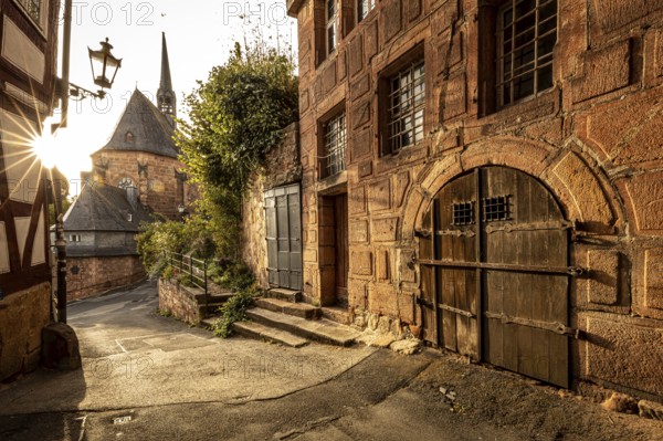 Romantic alleyway scene in the old town with sunlight, shadows and old architecture, The historic alleys and streets of the old town of Marburg
