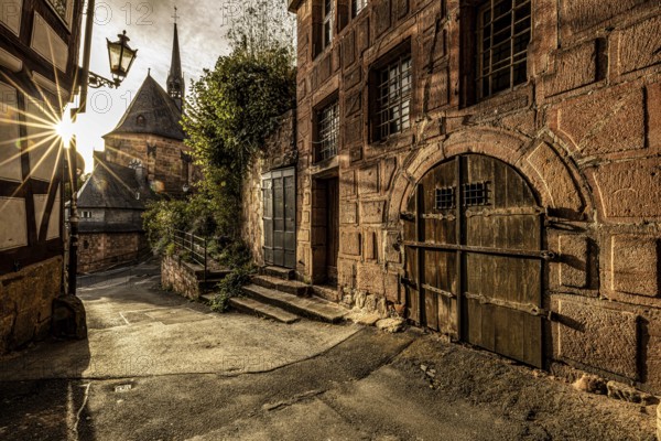 Historic alley with old charm and sunshine through the old town, The historic alleys and streets of the old town of Marburg