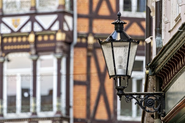 Nostalgic lantern in front of a half-timbered house with traditional architectural elements, The historic street lamps of Marburg an der Lahn in Hesse