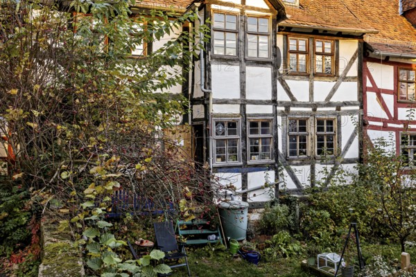 Idyllic garden with historic half-timbered house in autumn, the historic city center of Marburg in Hesse