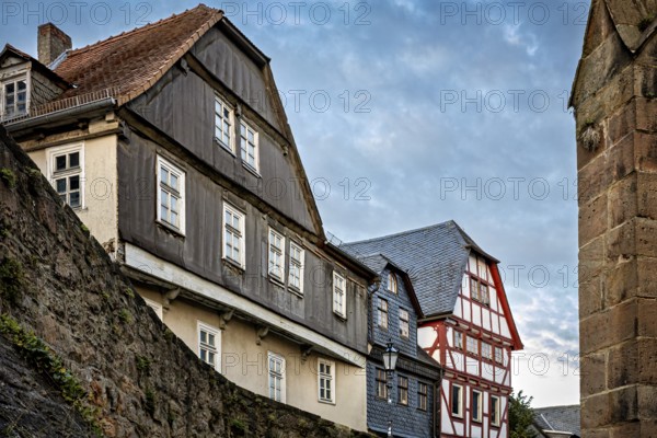 Historic buildings with tiled roofs along a city wall, The historic city center of Marburg in Hesse