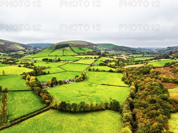 Autumn colours of Farms over River Wye and Road A470 from a drone, Llanidloes, Powys, Montgomeryshire, Wales, UK