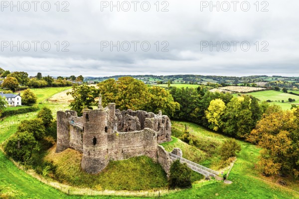 Autumn Colours over ruins of Grosmont Castle from a drone, Grosmont, Monmouthshire, Wales, UK