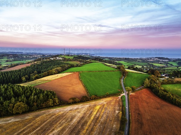Sunset of Devon Farms and Fields over Berry Pomeroy from a drone, Totnes, England, United Kingdom