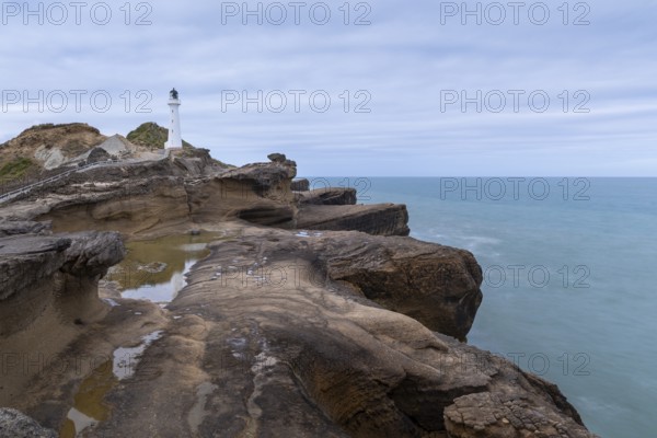 Castlepoint lighthouse on a rock, sea, long exposure. Castlepoint, Wairarapa Coast, Wellington Region, North Island, New Zealand