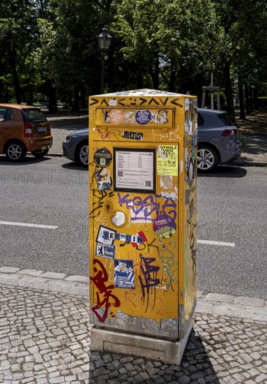 Deutsche Post letterbox with stickers and graffiti, Potsdam, Brandenburg, Germany