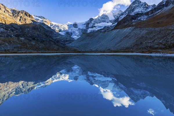 The Moiry glacier and mountain peaks are reflected in Lac de Chateaupre, Val d'Anniviers, Valais Alps, Canton of Valais, Switzerland