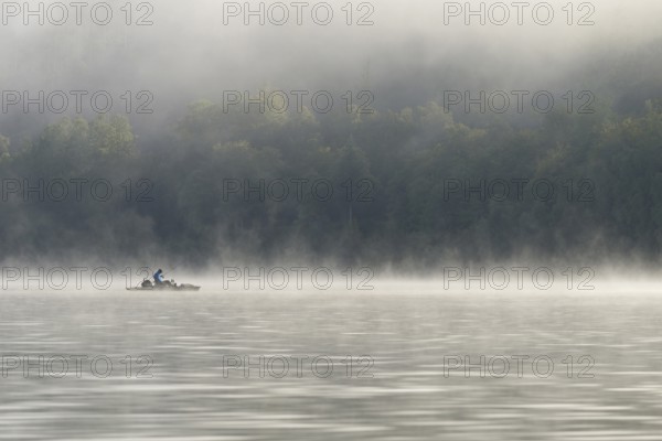 Hennesee, fog, rising clouds of fog, anglers in the boat, Hennetalsperre, Sauerland-Rothaargebirge nature park Park, North Rhine-Westphalia, Germany