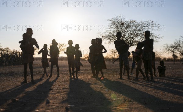 Himba children playing, evening mood, traditional Himba village, Kaokoveld, Kunene, Namibia