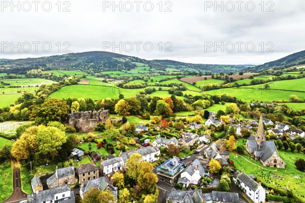 Autumn Colours over ruins of Grosmont Castle from a drone, Grosmont, Monmouthshire, Wales, UK