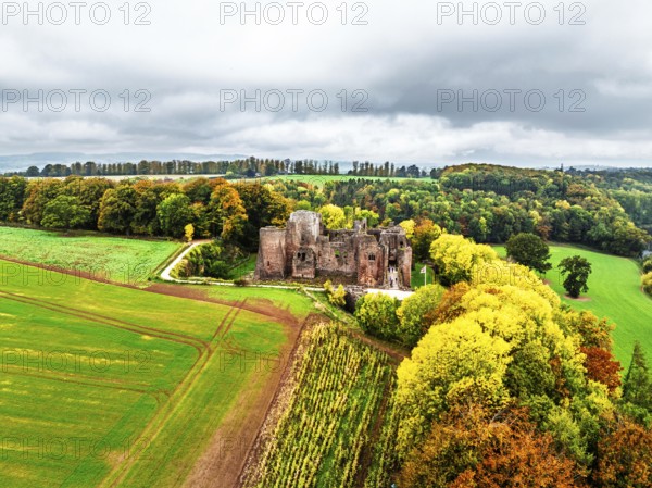 Autumn Colours over ruins of Goodrich Castle and River Wye from a drone, Goodrich, Herefordshire, England, United Kingdom