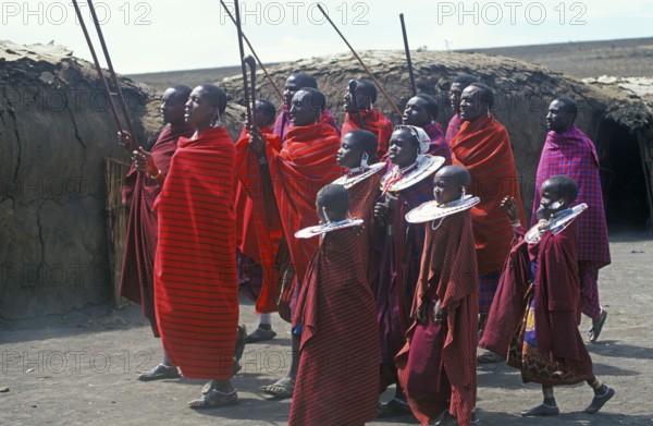 Maasai men and girls in their village in the Ngorongoro Crater dancing for tourists, Tanzania, Africa, June 2000, vintage, retro, old, historic