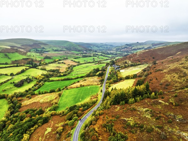 Autumn colours of Farms over River Wye and Road A470 from a drone, Llanidloes, Powys, Montgomeryshire, Wales, UK