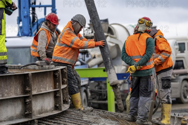 Concreting, concreting the foundation of a wind turbine, more than 600 cubic meters of concrete will be pumped into the foundation for over 7 hours, over 100 tons of reinforcing steel have been used, the wind turbine will have a hub height of 160 meters, part of a new wind farm in Sauerland, near Balve, North Rhine-Westphalia, Germany