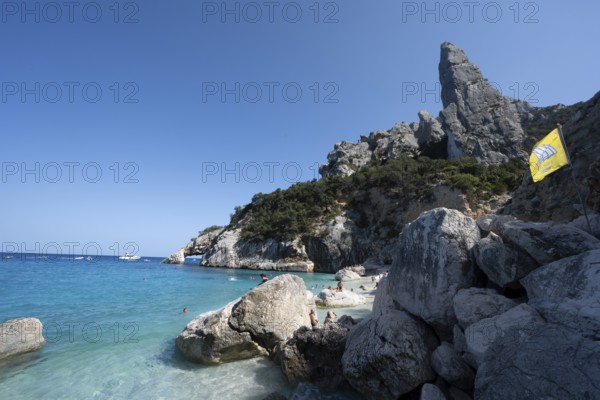 Light blue clear sea on a dream beach on Cala Goloritzé, picturesque rocky coast, steep coast with rock pin L'Aguglia, Golfo di Orosei, Baunei, Sardinia, Italy