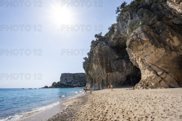 Sandy beach beach and steep cliffs with caves at Cala Luna, Golfo di Orosei, Baunei, Sardinia, Italy