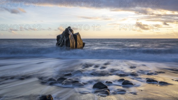 Sunset, waves and rocks in the sea, Praia Formosa, Madeira, Portugal