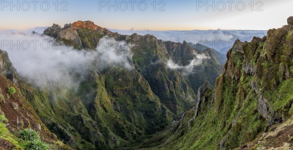 Sunrise at Pico do Arieiro, clouds of fog pass over mountain peaks, hiking trail PR1, Madeira, Portugal