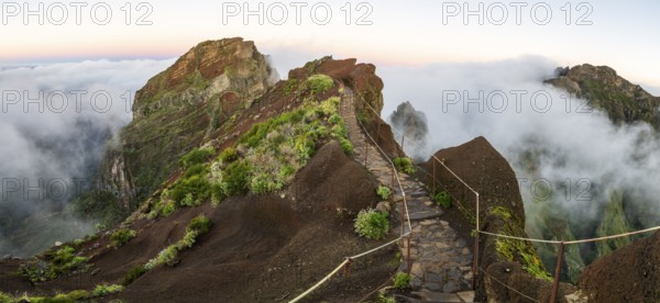 Sunrise at Pico do Arieiro, clouds of fog sweep over mountain peaks, sea of fog, hiking trail PR1, Madeira, Portugal