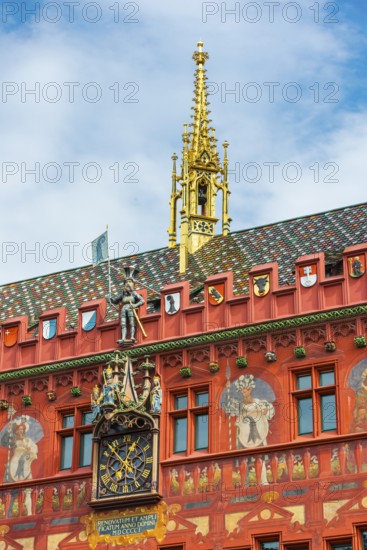 Exterior view with a magnificent clock at the Red Town Hall, Market Square, Basel