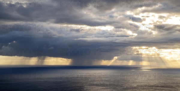 Sunset, sun rays over sea, dark rain cloud, rain, Madeira, Portugal