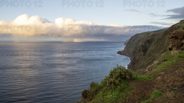 Sunset, rainbow over sea, at Farol da Ponta do Pargo lighthouse, west coast, Madeira, Portugal