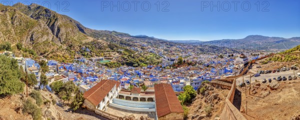 Panoramic picture of a city with distinctive blue buildings and mountainous surroundings, Morocco, Chefchaouen