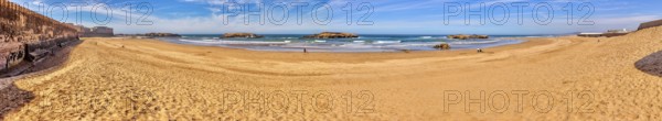 Extensive sandy beach with calm sea and clear sky, Morocco, Essaouira, coast, panorama