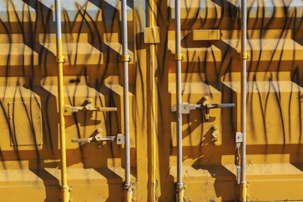 Close-up of locked doors on yellow painted metal boxed shaped shipping container, Quebec, Canada