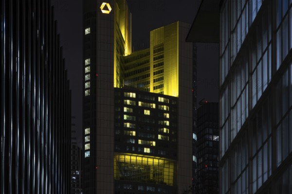A yellow heart glows on the façade of the Commerzbank Tower in Frankfurt am Main at Christmas time in the evening, Frankfurt am Main, Hesse, Germany